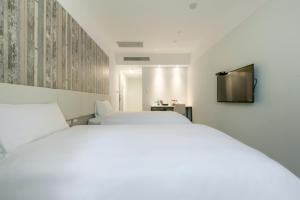 Voodi või voodid majutusasutuse Fengjia JinRui Hotel toas