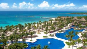 an aerial view of a resort with palm trees and the ocean at Barceló Maya Colonial - All Inclusive in Xpu Ha
