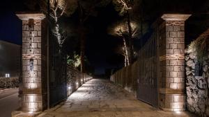 a fence and a street at night at Oasi Olimpia Relais in SantʼAgata sui Due Golfi