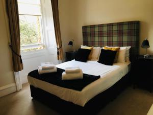 Postel nebo postele na pokoji v ubytování Bayswell Park Hotel