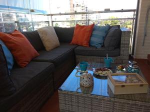 a living room with a couch and a table at Apartamento cerca playa San Juan in Alicante