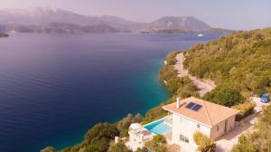 an aerial view of a house on the shore of a lake at Meganisi Blue Villa in Meganisi