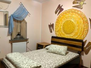 a bedroom with a bed and a large yellow plate on the wall at Arcadia in Kharkiv