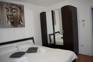 a bedroom with a bed and a large mirror at Sunrise in Alba Iulia