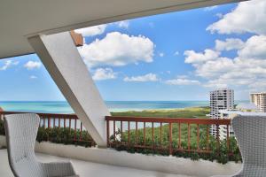 a balcony with chairs and a view of the ocean at Naples Grande Beach Resort in Naples