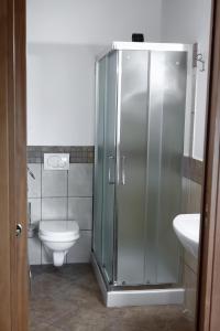 a bathroom with a shower and a toilet and a sink at Corte San Petronio in Castagnolo