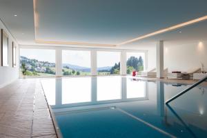 a room with a pool with a view of the mountains at Hotel Rössle in Bernau im Schwarzwald