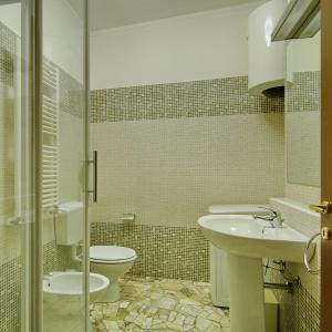 a bathroom with a sink and a toilet at Milan Apartment Rental in Milan