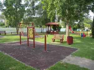 a park with a playground with a swing set and a bench at Apartment in Balatonbereny/Balaton 18074 in Balatonberény