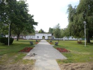 a walkway in a park with benches and a building at Apartment in Balatonbereny/Balaton 18074 in Balatonberény