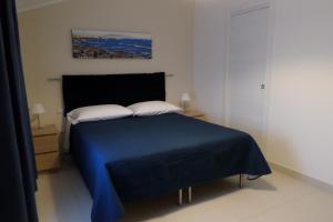 a bedroom with a blue bed with two pillows at B&B Mansarda del Sole in Naples