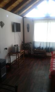 a living room with a television and a window at Cabaña 2 a 4 personas por dias in Olmué
