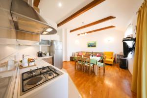 a kitchen and living room with a table and chairs at Apartment Milka with sea view in Tisno