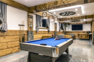 a pool table in a room with wooden walls at Zakątek pod Grapą in Białka Tatrzańska