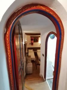an archway into a room with a living room at Dar naya in Chefchaouene