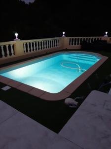 a swimming pool at night with a basketball hoop in it at Ribellu in Bastia