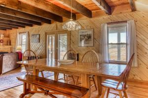 a dining room with a wooden table and chairs at Split Pine Cabin in Pagosa Springs