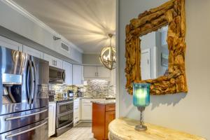 a kitchen with a mirror and a vase on a table at Bluewater Apartments in Orange Beach