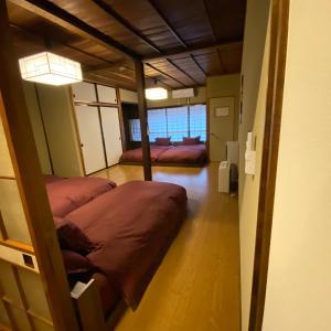 a room with two bunk beds in it with a hallway at Private House HidaTakayama in Takayama