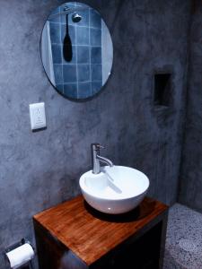 
a white sink sitting under a mirror in a bathroom at Hostel Hospedarte Centro in Guadalajara
