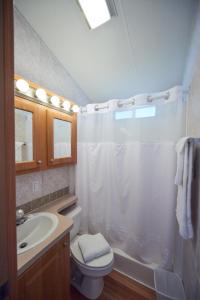a bathroom with a white shower curtain and a sink at Bethpage Two-Bedroom Cottage 4 in Urbanna