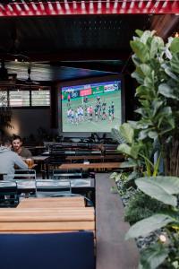 een kamer met een groot scherm met een voetbalspel erop bij Hotel Jesmond in Jesmond
