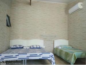 Ένα ή περισσότερα κρεβάτια σε δωμάτιο στο Itaipuaçu Residencia Cajueiros I