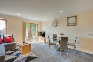 a living room with a couch and a table at Mica Point City Centre Apartment in Birmingham
