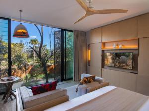 a bedroom with a bed and a large window at Wildlife Retreat at Taronga in Sydney