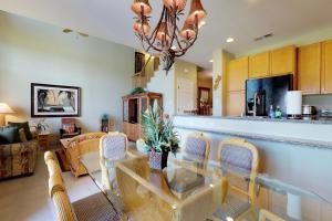 a kitchen and living room with a table and chairs at Waikoloa Colony Villas #1104 in Waikoloa