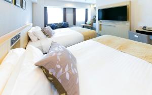 ART Hotel Oita客房内的一张或多张床位