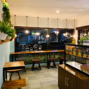 a restaurant with a fish tank and tables and benches at The Nalaya Hotel & Resto in Borobudur