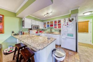 a kitchen with white appliances and green walls at Paradise in the Pines in Brian Head