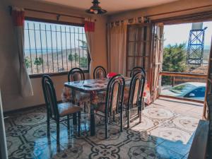 a dining room with a table and chairs and a balcony at Terra Nostra in Villa Ciudad de América