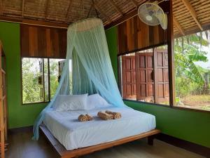 מיטה או מיטות בחדר ב-Kham Ecolodge
