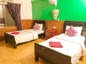 מיטה או מיטות בחדר ב-Jasmine Lodge Siem Reap