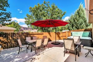 a patio with a table and chairs and an umbrella at Cottonwoods 57 in Moab