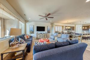 a living room with blue couches and a kitchen at Legacy Land: Paradise Village #70 in Santa Clara