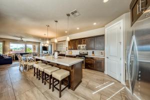 a kitchen with a large island with bar stools at Legacy Land: Paradise Village #70 in Santa Clara