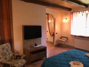 a hotel room with a bed and a flat screen tv at Colle Cornetto in Spoleto
