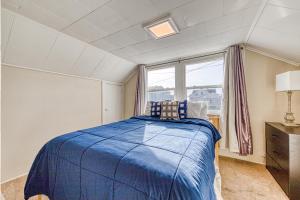 a bedroom with a blue bed and a window at Dolphin 2 in Rockaway Beach