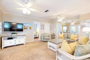 a living room with a couch and a tv at Harmony House in Anna Maria