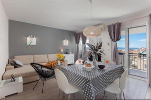 a living room with a table and a couch at Sea view Ela Apartments in Podgora