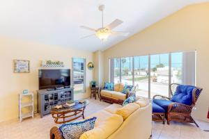 a living room with a couch and a tv at Long Island Village Unit 111 in Port Isabel