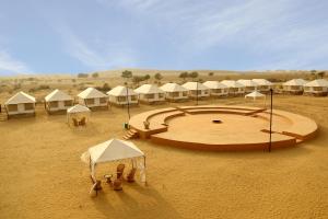 a group of tents in the middle of a desert at Exotic Luxury Camps in Jaisalmer