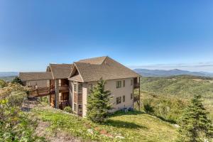 a house on a hill with mountains in the background at Reserve 19-D in Sugar Mountain