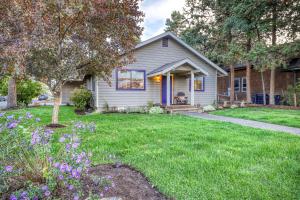 a house with a yard with purple flowers at Perfectly Placed Plum Cottage in Bend