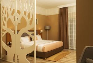 Postel nebo postele na pokoji v ubytování Mado Hotel