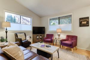 a living room with a couch and chairs and a tv at Perfectly Placed Plum Cottage in Bend