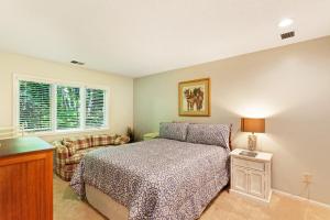 a bedroom with a bed and a chair at Harbor Cove #9 in Harbor Springs